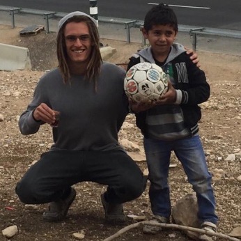 Playing futbol with a young Bedouin boy